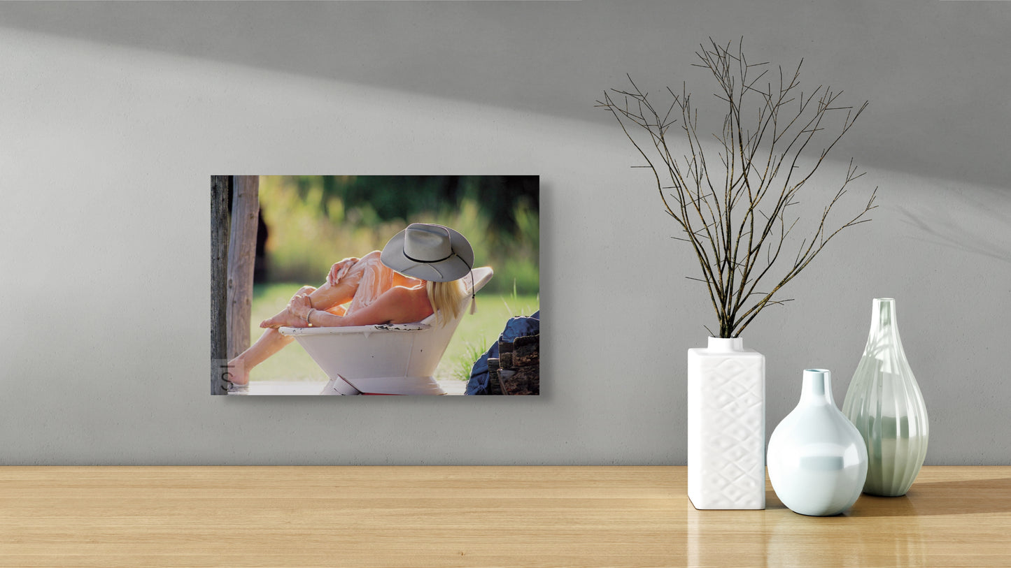 A cowgirl bathes in a bath tub in this western image by David Stoecklein. Cowgirl photography by David Stoecklein