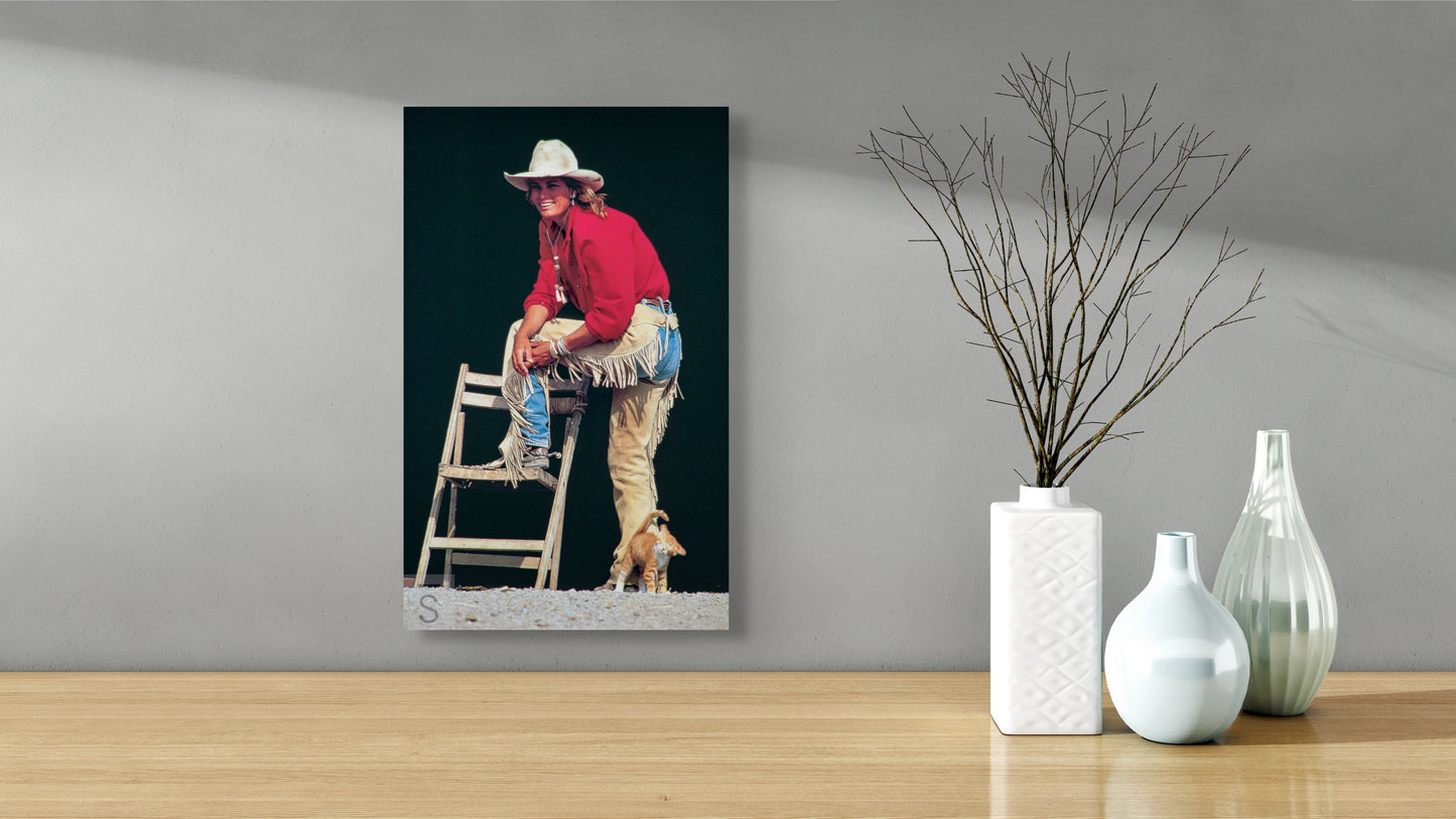 A cowgirl, chaps, and a kitten. Western fine art by David Stoecklein.