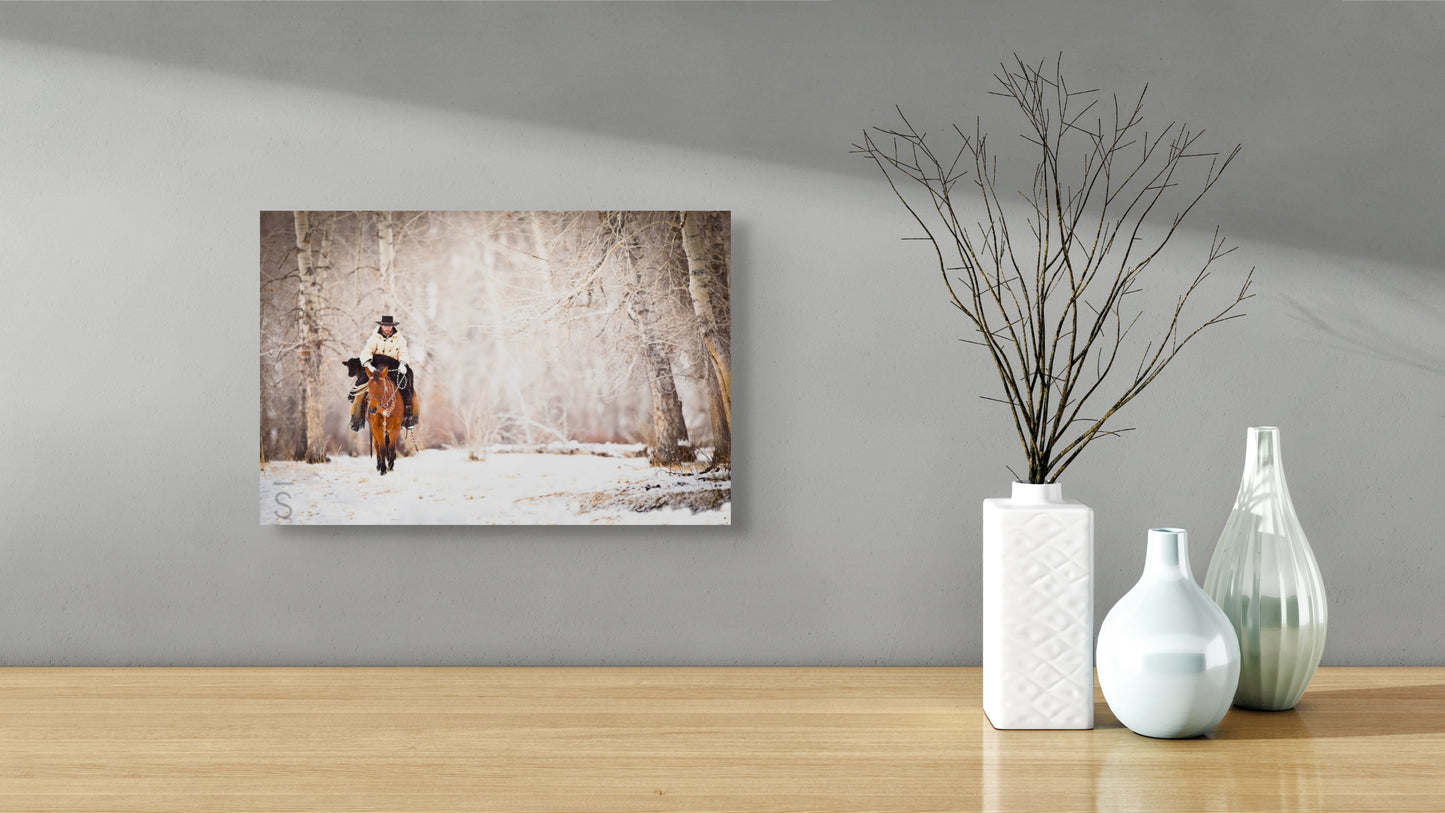 The magic of winter, featuring Caleb Munns riding his horse with a calf in tow at 6x Ranch in Mackay, Idaho. Western Fine Art Photography by David Stoecklein