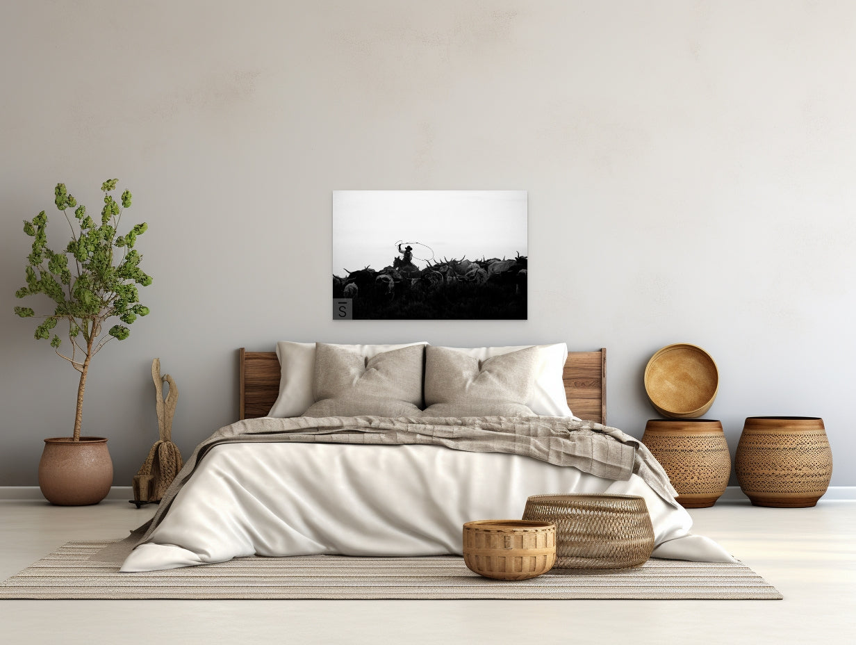 A cowboy herds his cattle. Black and white western fine art photography by David Stoecklein. 