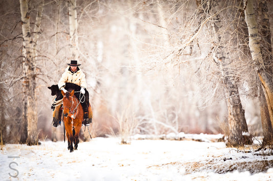 The magic of winter, featuring Caleb Munns riding his horse with a calf in tow at 6x Ranch in Mackay, Idaho. Western Fine Art Photography by David Stoecklein,